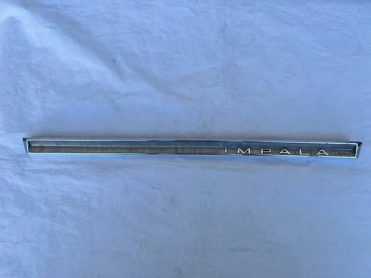 USED ORIGINAL GM 1964 CHEVROLET IMPALA GLOVE BOX DOOR EMBLEM CHROME TRIM MOLDING
